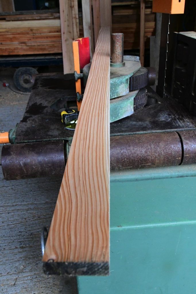 Larch on planer showing straightness of the grain